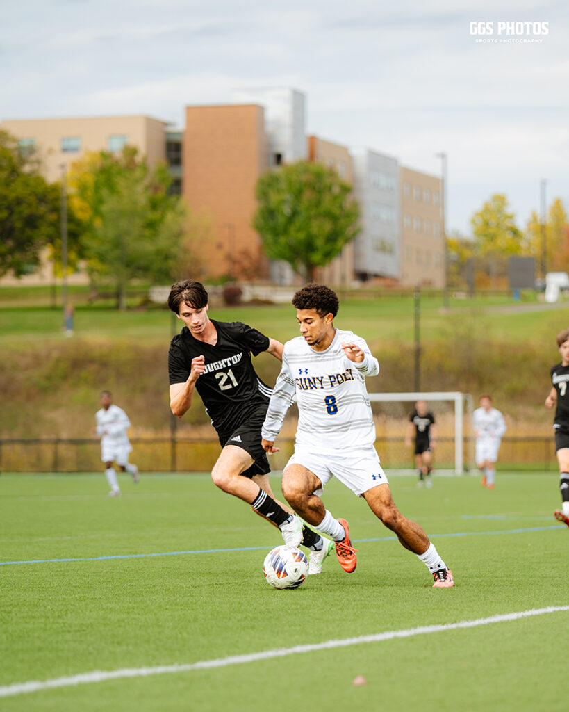 Photo of SUNY Poly soccer player driving past a defender.