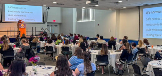 Photo of speaker and participants at the Poly LEAD event.