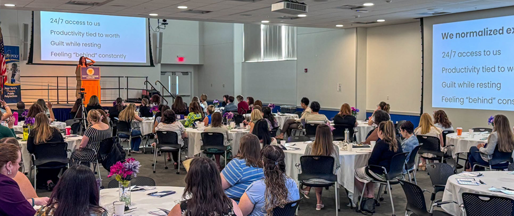 Photo of speaker and participants at the Poly LEAD event.