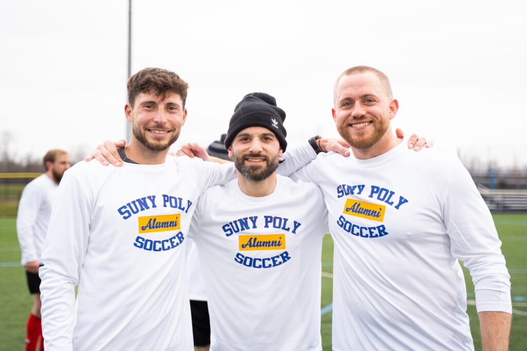 Soccer Alumni smiling for the photo. 