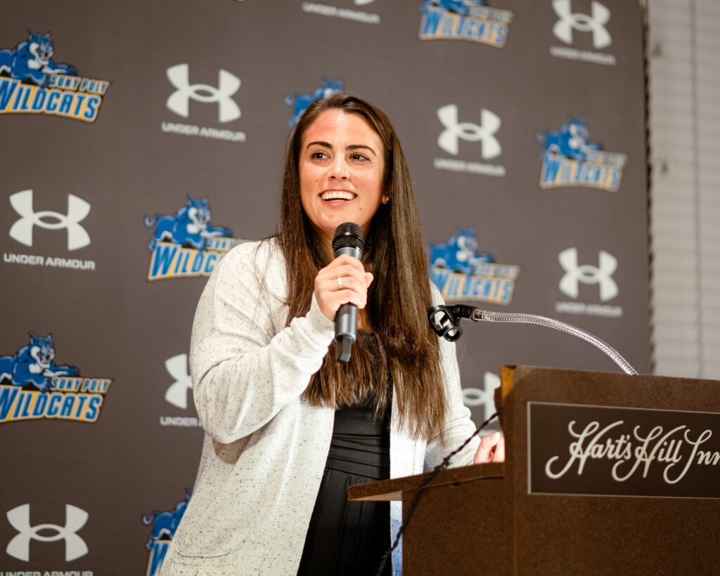 Woman gives speech at Homecoming Weekend.