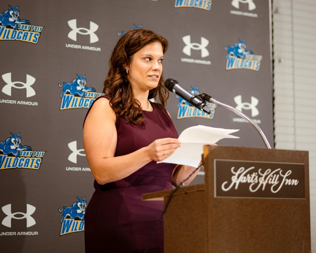 Woman gives speech at Homecoming Weekend.