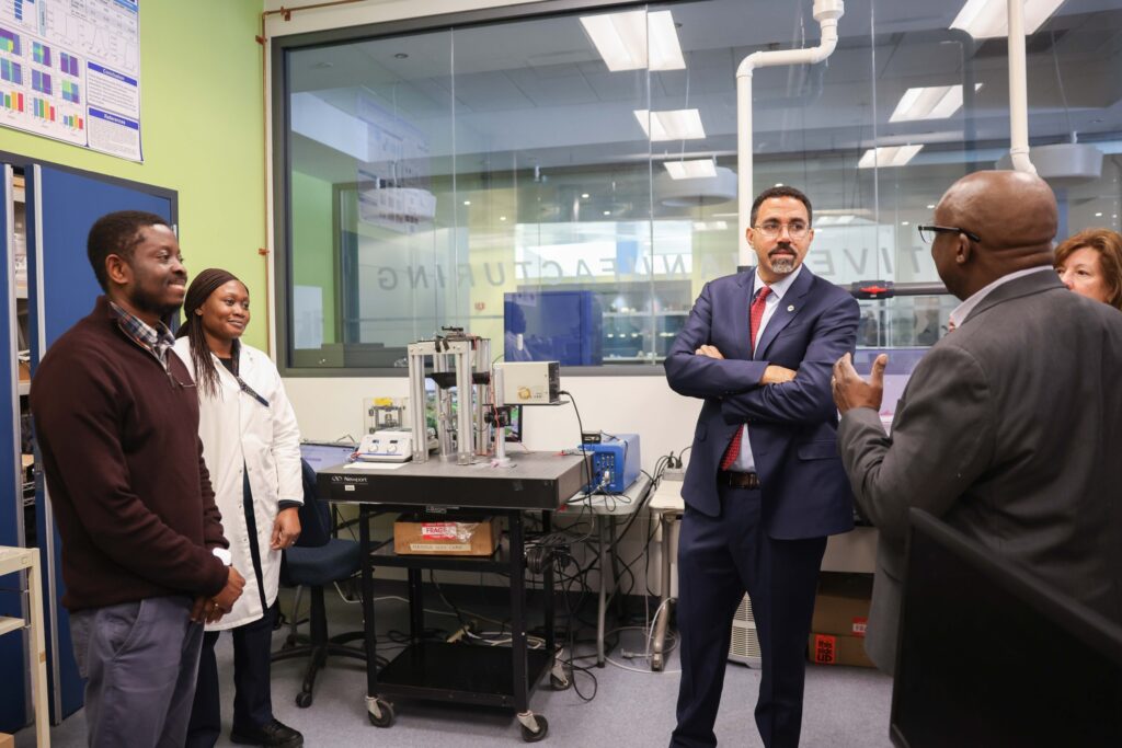 Chancellor John B. King Jr, President Soboyejo and other staff in the CGAM Labs.