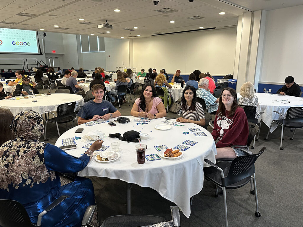 Group of students playing bingo at Homecoming Weekend.