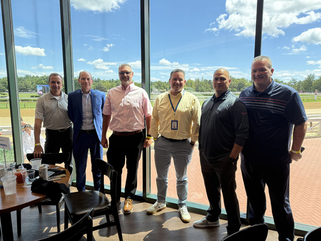 Group of Alumni photographed at the Saratoga Race Track.