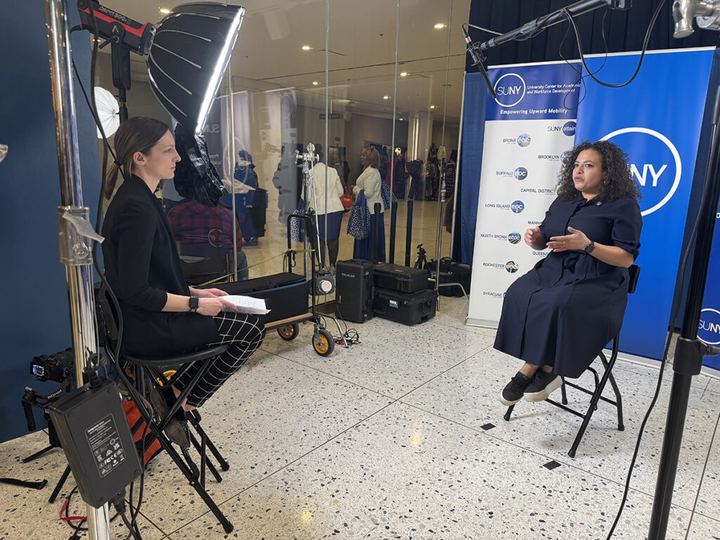 Photographed: Allison conducting and interview with a SUNY staff member.