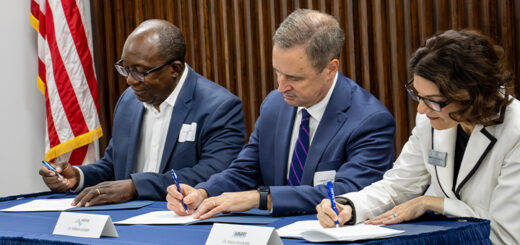 SUNY Poly President and MVCC staff at a table signing.