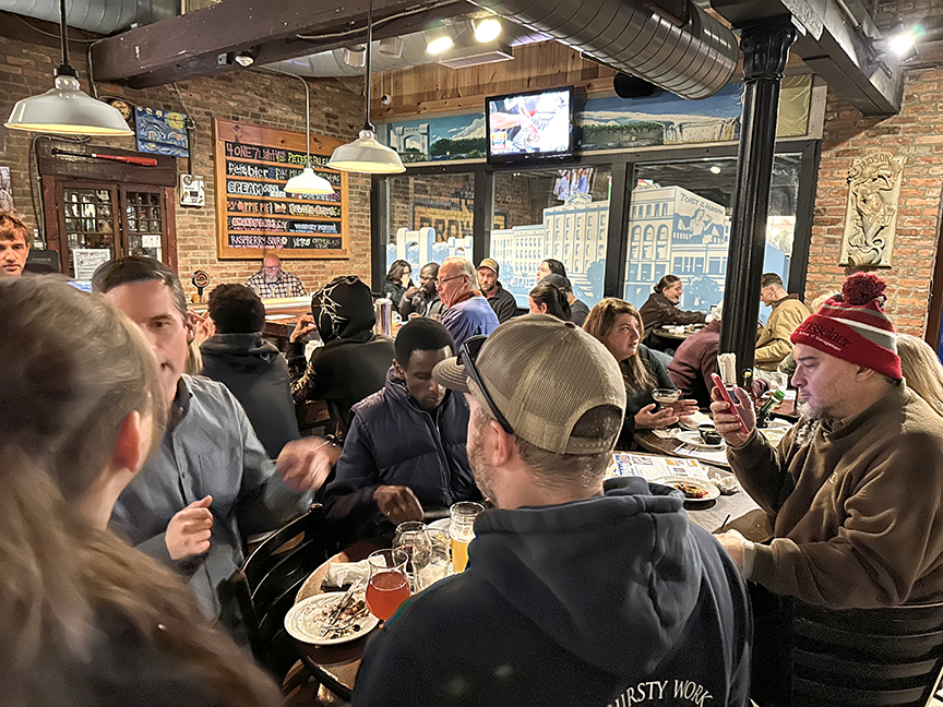 Alumni photographed eating dinner in the Brown's Brewing Company.