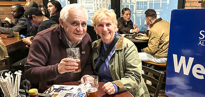 Two alumni photographed in Brown's Brewing Company.